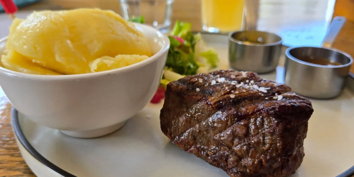 Porterhouse steak with roast potatoes, salad, and beer at The Station Hotel Footscray